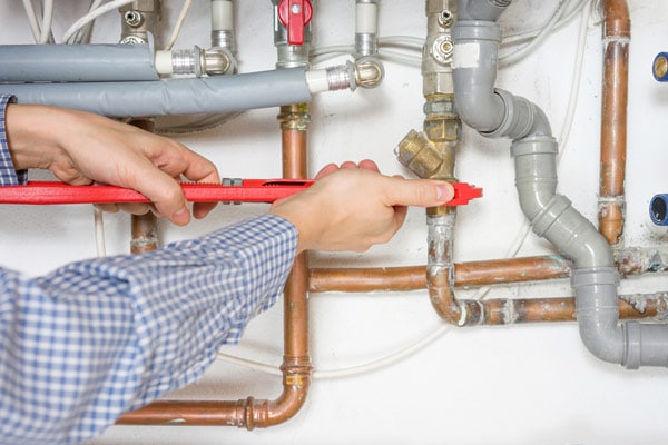 Plumber Fixing Central Heating System — Plumber Central Coast in Forresters Beach, NSW